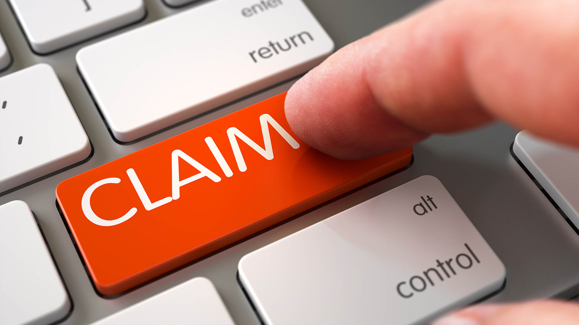 A person pressing a computer keyboard key labeled as "claim".