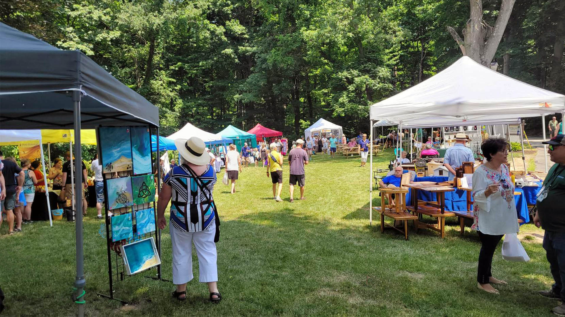 An image of attendees on the lawn of Wildwood Cultural Center during the 2024 Arts & Wine Fest.