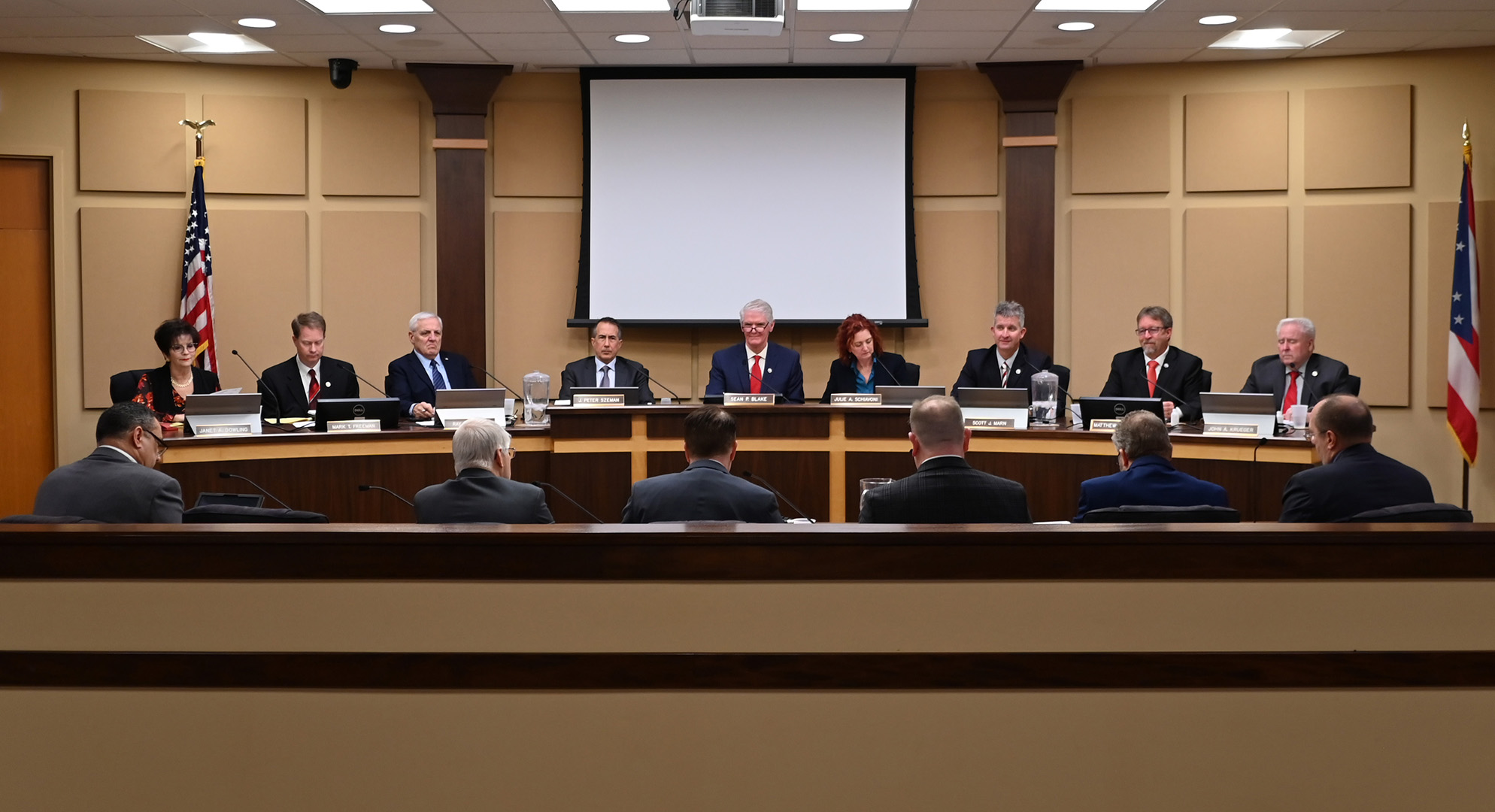 Image of Mentor City Council facing members of administration. 