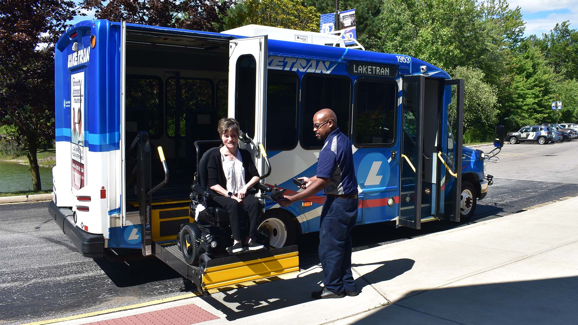 Laketran Driver Jerry R. assists passenger Kim Stenger alighting a Dial-a-Ride bus