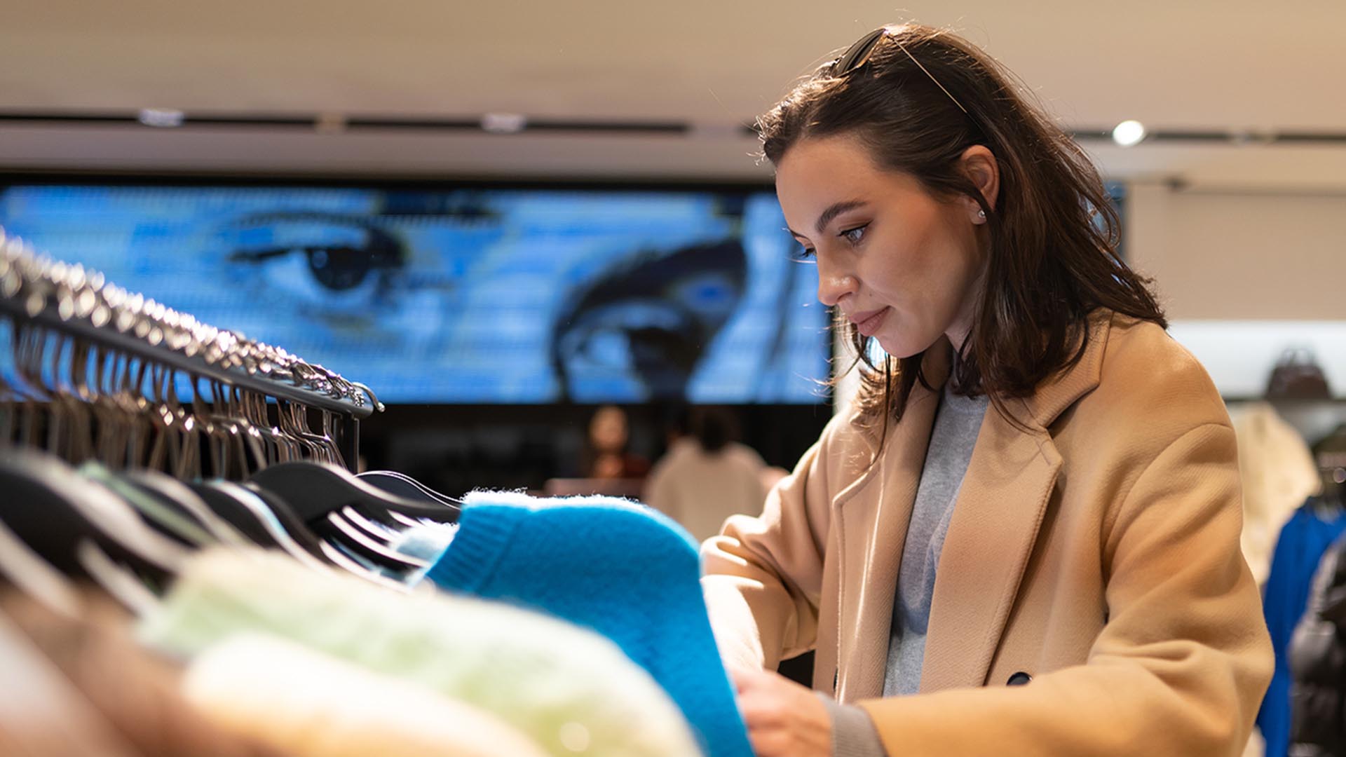 Person shopping for clothes in a retail store. 