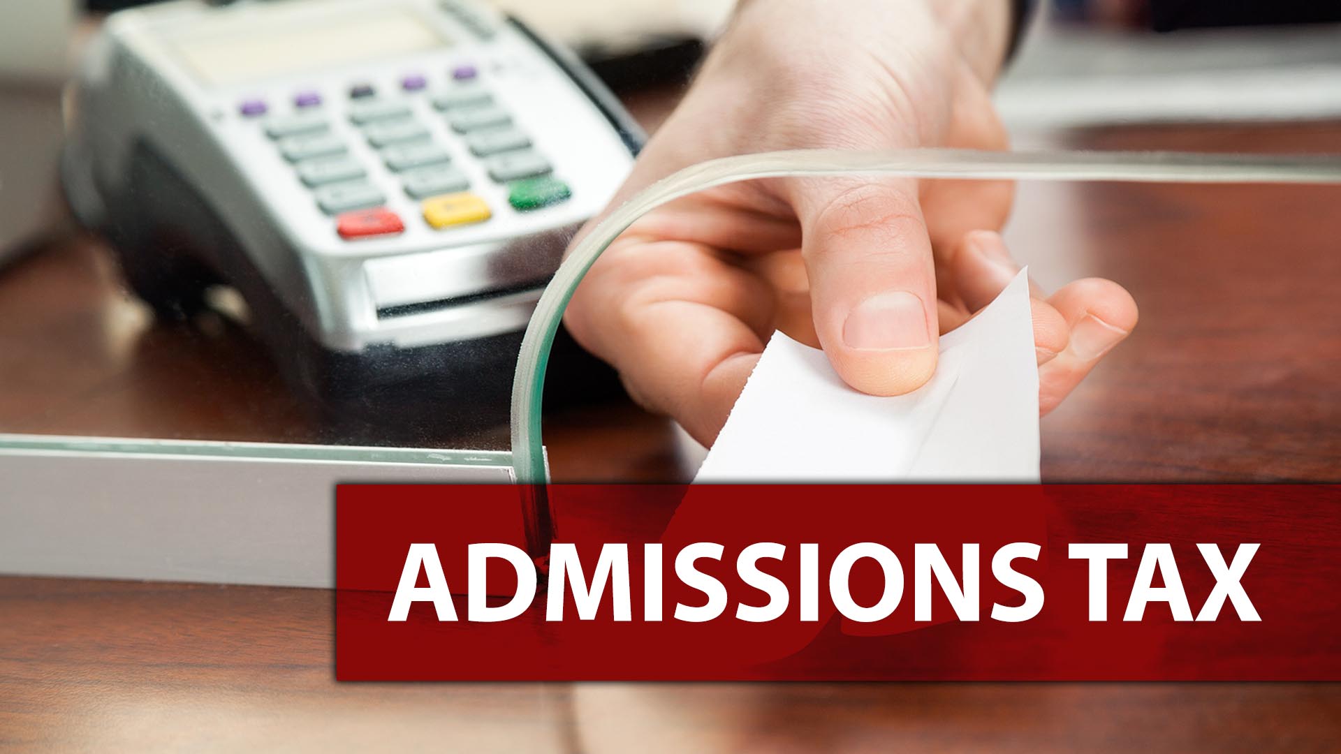Ticket taker handing ticket through slot with "Admissions Tax" copy overlayed.
