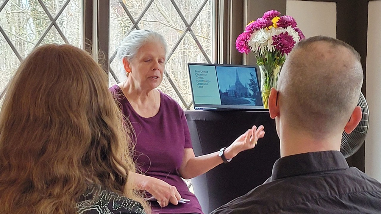 An author addressing an audience at the Books in the Woods Fair at Wildwood Cultural Center.