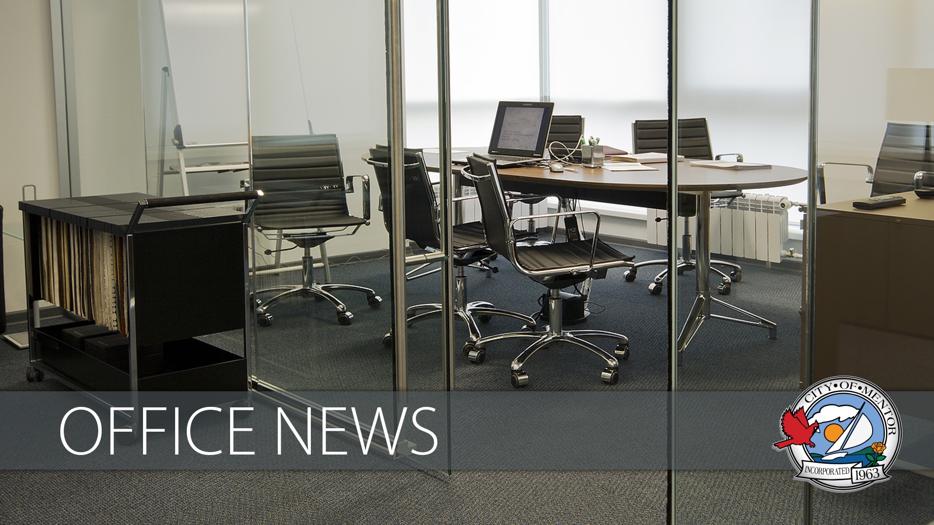 Image of an empty conference room with an overlay of the Mentor city seal and the words "office news".