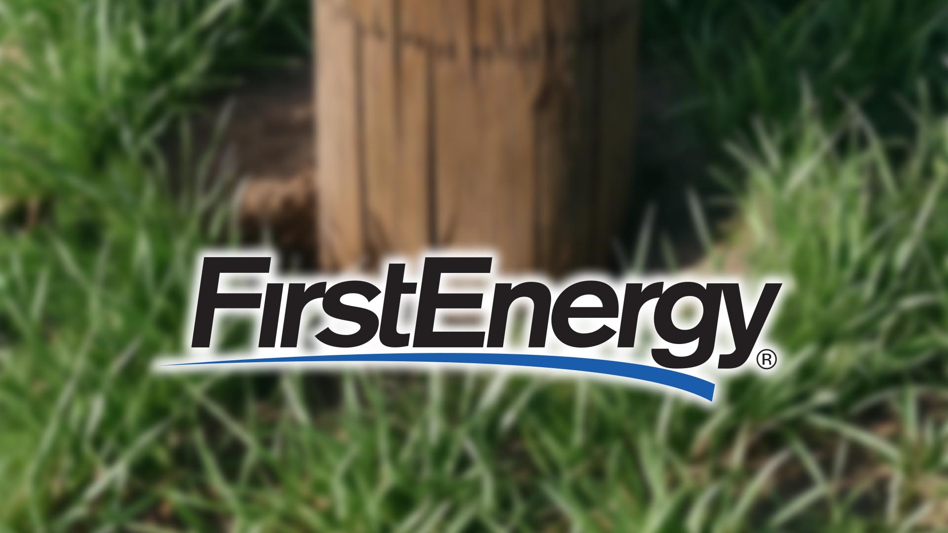 FirstEnergy Logo overlayed on blurred image of the base of a utility pole.