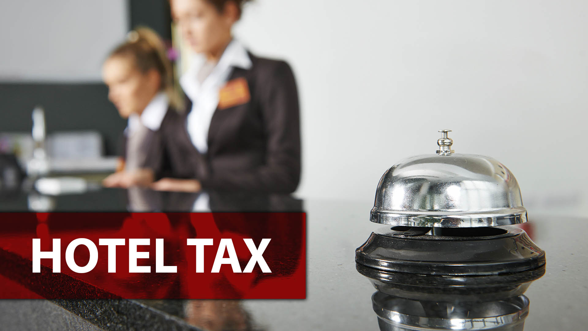 The front check in desk at a hotel with a ringer and the words "Hotel Tax" overlayed.