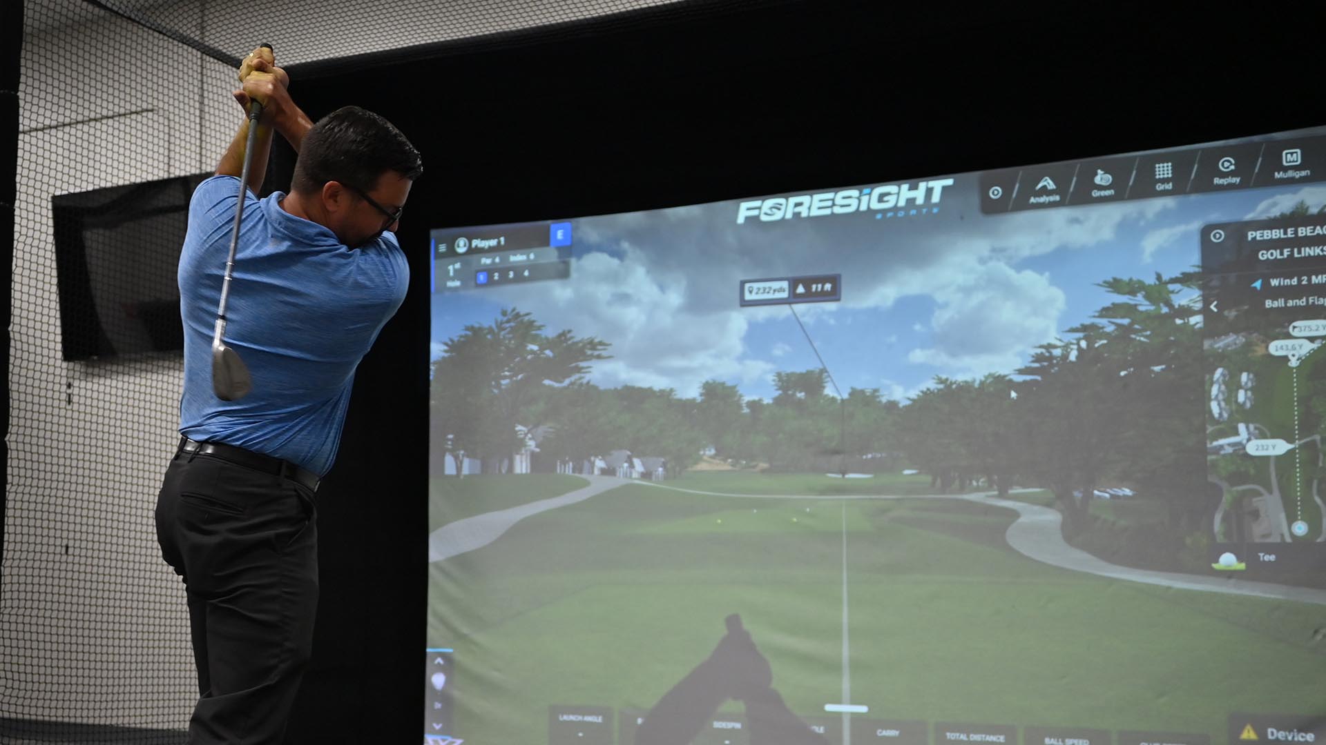 Person using the Foresight golf simulator at the Mentor Community Recreation Center. 