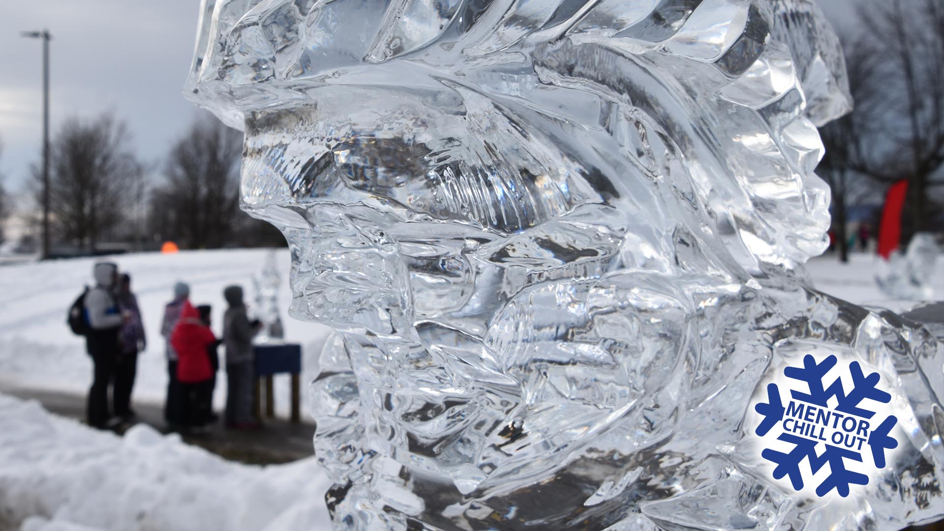Close up of an ice sculpture with people off focus in the background. Mentor Chill out logo is emblazoned in the bottom right corner.