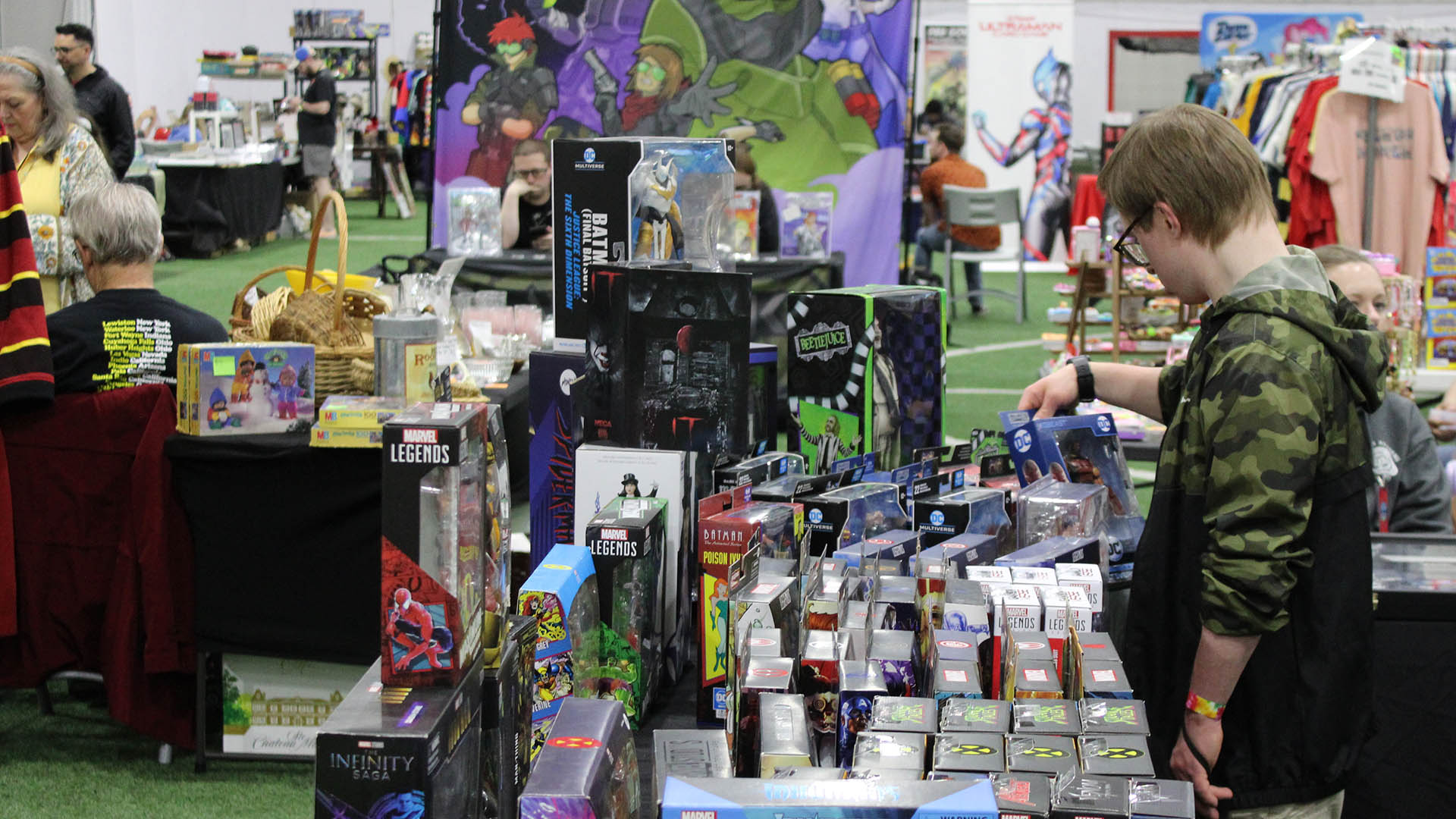Person browsing merchandise at the 2025 Mentor Pop Culture Show at the Mentor Community Recreation Center
