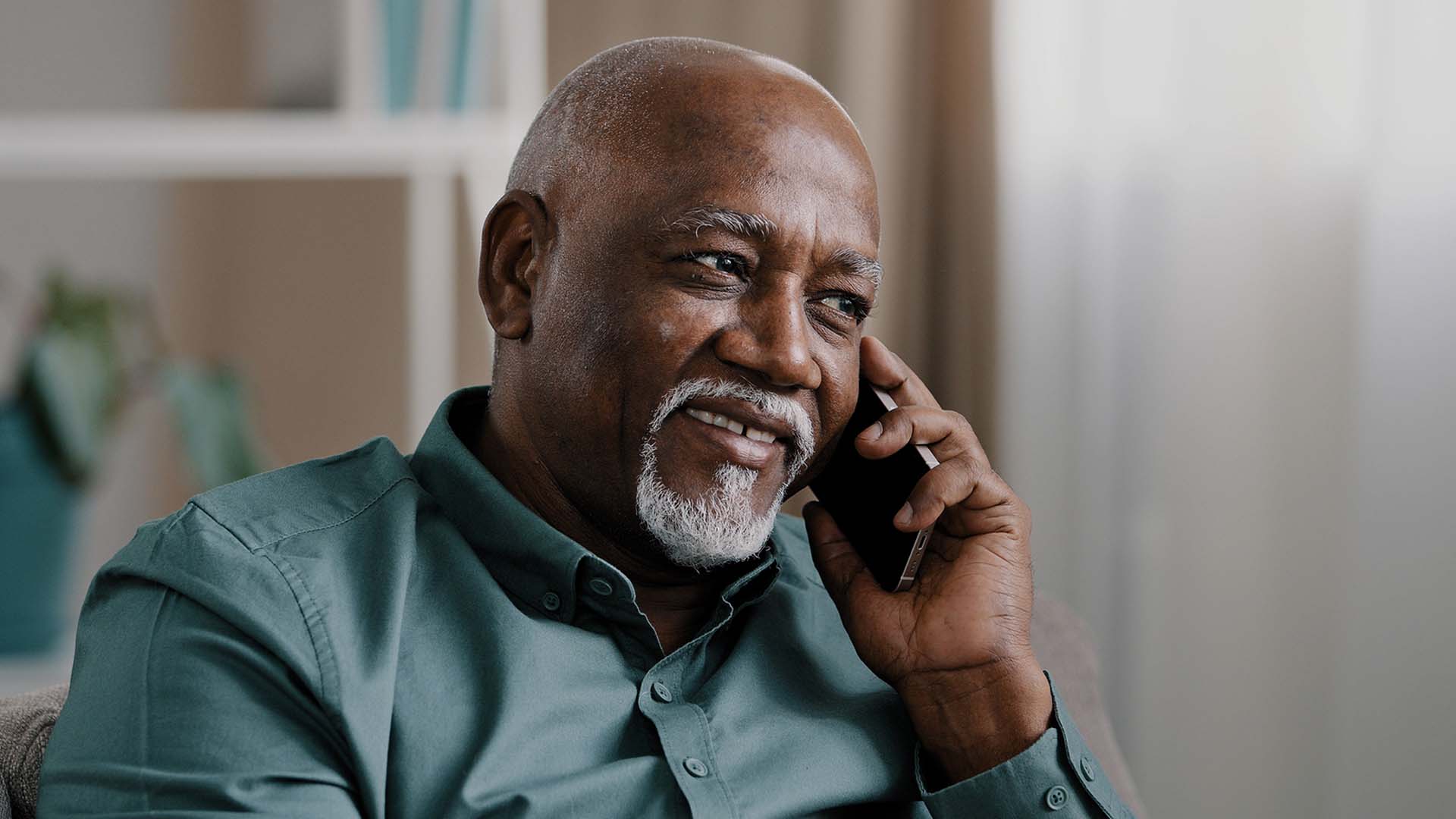 A senior speaking into a cell phone.