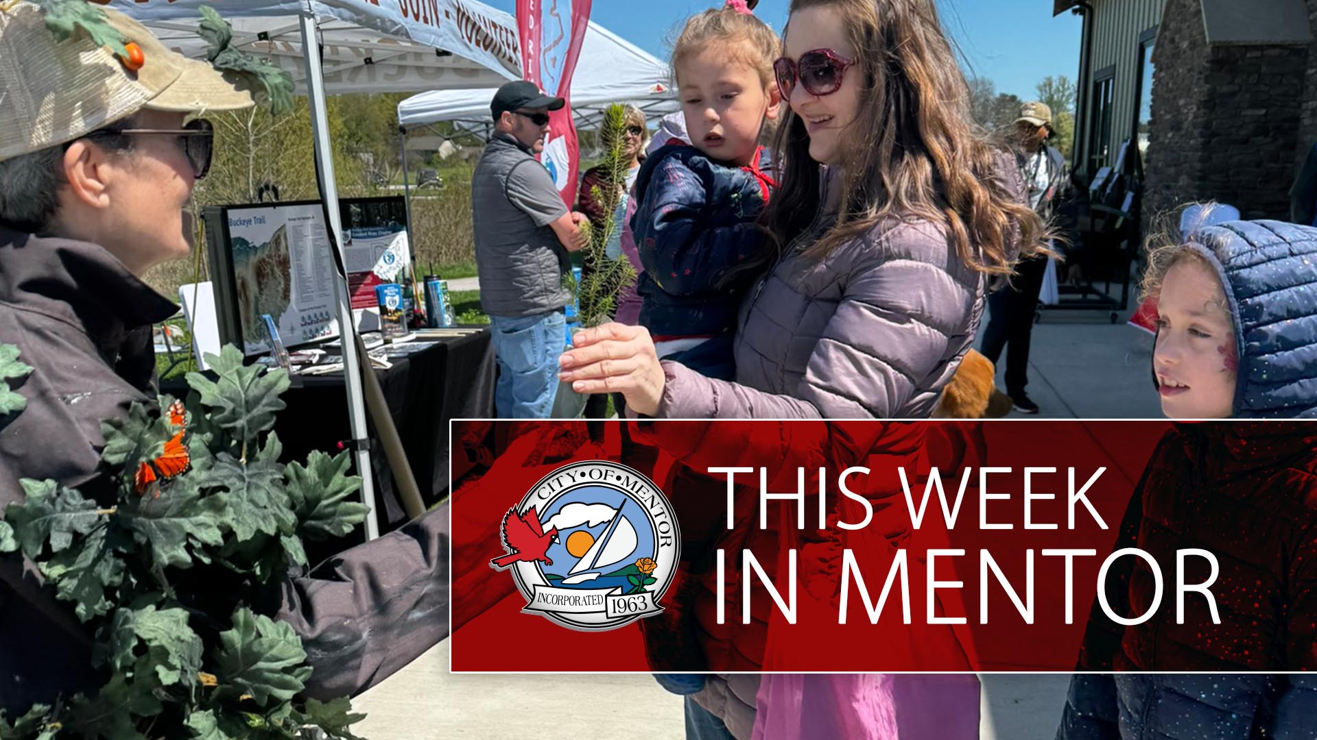 An image of people attending an Earth Day event at Springbrook Gardens Park in Mentor with "This Week in Mentor" overlayed on a red rectangle.