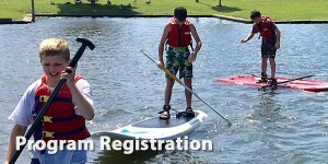 Group of boys learning to stand up paddle board